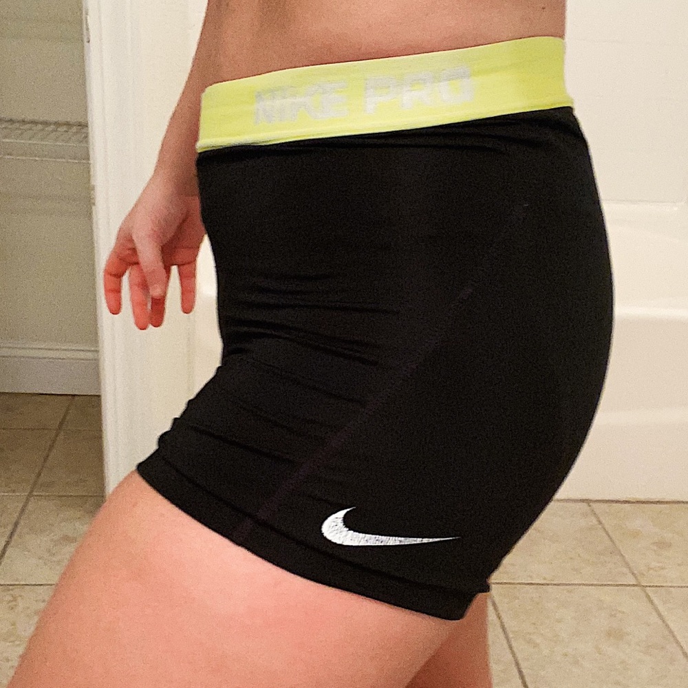 Black nike pros with yellow/green band